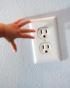 kids fingers reaching to outlet