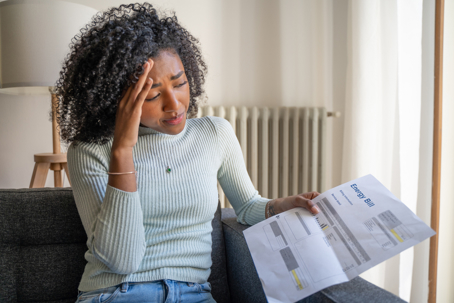 shocked black woman having problem paying energy bill expenses